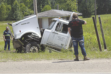 Log truck wrecks on U.S. 82
